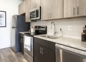 Thumbnail 5 of 43 - a kitchen with stainless steel appliances and a granite counter top