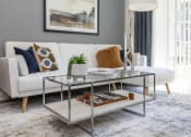 Thumbnail 9 of 43 - a living room with a white couch and a glass coffee table