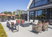 Thumbnail 42 of 43 - a patio with chairs and tables outside of a building