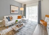 Thumbnail 7 of 43 - a living room with a white couch and a glass coffee table