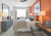 Thumbnail 10 of 43 - a bedroom with a bed and a desk with a laptop