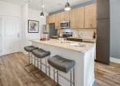 Thumbnail 3 of 43 - a kitchen with an island with three stools