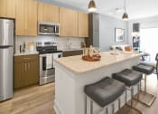 Thumbnail 2 of 43 - a kitchen with an island and stools in a house