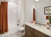 Thumbnail 13 of 43 - a bathroom with a shower toilet and sink and a mirror
