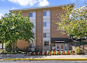 Thumbnail 17 of 18 - A brick building with a leasing office on the ground floor.