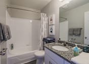 Thumbnail 15 of 19 - a bathroom with a sink and a shower and a toilet