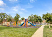 Thumbnail 12 of 12 - A playground with a blue and orange slide.