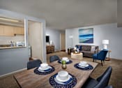 Thumbnail 10 of 11 - A dining room with a wooden table set with plates and napkins.