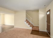 Thumbnail 13 of 29 - an empty living room with a staircase in a house