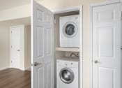 Thumbnail 15 of 29 - a small laundry room with a washing machine and a washer and dryer