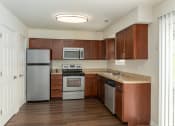 Thumbnail 17 of 29 - a kitchen with stainless steel appliances and a granite counter top
