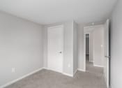 Thumbnail 20 of 29 - a bedroom with a white door and a closet
