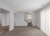 Thumbnail 22 of 29 - a living room with a carpeted floor and a staircase