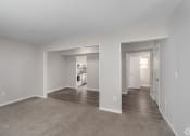 Thumbnail 21 of 29 - the living room and dining room of a new home with carpet and white walls
