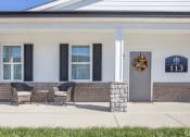 Thumbnail 8 of 22 - the front porch of a home with chairs and a wreath on the door