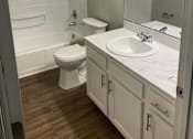 Thumbnail 6 of 42 - A white toilet and sink in a bathroom.