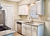 Thumbnail 12 of 15 - a kitchen with white cabinets and a sink