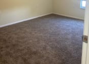 Thumbnail 19 of 25 - a bedroom with a ceiling fan and carpet
