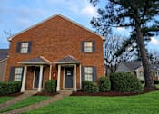 Thumbnail 3 of 15 - A red brick house with a tree in front.