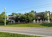 Thumbnail 9 of 23 - a row of houses on the side of a road