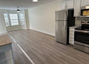 Thumbnail 11 of 23 - an empty kitchen and living room with a stainless steel refrigerator