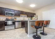Thumbnail 3 of 22 - a kitchen with a counter top with two bar stools