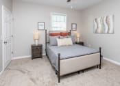 Thumbnail 5 of 22 - a bedroom with a bed and two lamps and a window
