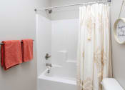 Thumbnail 19 of 22 - a bathroom with a shower and a toilet and a shower curtain