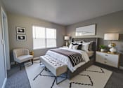 Thumbnail 24 of 26 - A bedroom with a large bed, a chair, and a nightstand.