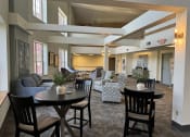 Thumbnail 14 of 25 - a large living room with tables and chairs