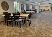 Thumbnail 12 of 25 - a large dining room with tables and chairs in a building