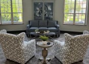 Thumbnail 18 of 25 - a view from above of a living room with couches and a table and windows