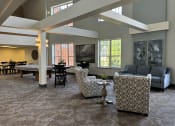 Thumbnail 11 of 25 - a large living room with couches and chairs and a dining table