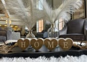 Thumbnail 13 of 25 - a coffee table with hearts and a sign that reads home