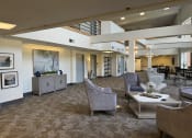 Thumbnail 16 of 25 - a lobby with couches and chairs and a coffee table