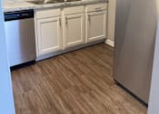 Thumbnail 38 of 42 - A kitchen with white cabinets and a stainless steel refrigerator.