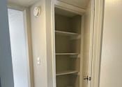 Thumbnail 42 of 42 - A white closet with a door open.