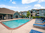 Thumbnail 15 of 38 - Pool With Lounge Chairs at Aventura at Richmond, St. Peters, Missouri