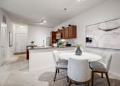 Thumbnail 21 of 38 - A modern kitchen with a dining table set for two. at Aventura at Richmond, St. Peters, 63376