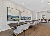 Thumbnail 7 of 16 - A dining room with a long table and chairs.