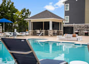 Thumbnail 18 of 23 - A pool with sun lounger