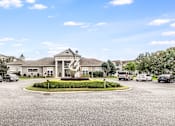 Thumbnail 1 of 30 - A large building with a circular driveway in front of it, Plantation Crossing, Lafayette, LA, 70508