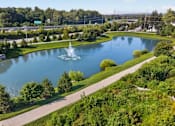 Thumbnail 36 of 41 - A large pond with a fountain in the middle of it.