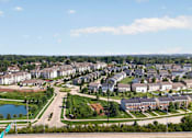 Thumbnail 41 of 41 - A view of a residential area with houses, a lake, and a green flag.