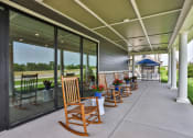 Thumbnail 25 of 28 - a long porch with rocking chairs and a gazebo at Aventura at Hawk Ridge, Lake St Louis, 63367