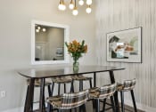 Thumbnail 19 of 28 - a dining room with a table and chairs and a mirror  at Aventura at Hawk Ridge, Lake St Louis, MO