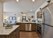 Thumbnail 4 of 28 - a kitchen with stainless steel appliances and granite counter tops  at Aventura at Hawk Ridge, Lake St Louis, MO, 63367