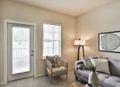 Thumbnail 12 of 28 - a living room with a couch and a chair  at Aventura at Hawk Ridge, Lake St Louis