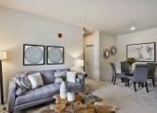 Thumbnail 10 of 28 - a living room and dining room with a couch and a table  at Aventura at Hawk Ridge, Lake St Louis, MO