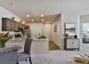 Thumbnail 8 of 28 - an open kitchen and living room with a couch and a table  at Aventura at Hawk Ridge, Lake St Louis, 63367